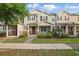 Charming tan two-story townhome with manicured lawn and covered front porch at 5892 Soter Ln, Windermere, FL 34786
