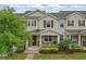 Attractive two-story townhome with covered entry, beautiful landscaping, and shutters at 5892 Soter Ln, Windermere, FL 34786