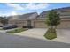 Well maintained townhome featuring a two-car garage, manicured landscaping, and a traditional exterior elevation at 5892 Soter Ln, Windermere, FL 34786