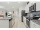 Modern kitchen with granite countertops, stainless steel appliances and an eat-in island at 5892 Soter Ln, Windermere, FL 34786
