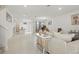 Bright and open living room with tile floors, modern decor, and staircase access at 5892 Soter Ln, Windermere, FL 34786