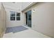 This patio features neutral walls, sliding glass doors to the home's interior, and space to relax and entertain at 5892 Soter Ln, Windermere, FL 34786