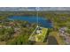 Aerial view of a lakeside estate showcasing a sprawling property with mature trees and waterfront access at 6082 Twin Lakes Dr, Oviedo, FL 32765