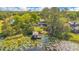 Expansive aerial view of a home's exterior with a private dock on a lily pad covered lake at 6082 Twin Lakes Dr, Oviedo, FL 32765