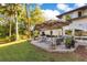 A large patio with outdoor seating, an umbrella, and a lush lawn, perfect for relaxation and entertainment at 6082 Twin Lakes Dr, Oviedo, FL 32765