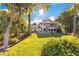 Expansive backyard featuring a well-maintained lawn, a patio, mature trees and a view of the home at 6082 Twin Lakes Dr, Oviedo, FL 32765