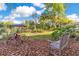 Serene backyard with a wooden bench, lush greenery, and a view of a covered dock and the waterfront at 6082 Twin Lakes Dr, Oviedo, FL 32765