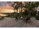 Scenic backyard with patio seating, fire pit, and tranquil lake views ideal for outdoor enjoyment at 6082 Twin Lakes Dr, Oviedo, FL 32765