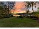 Lush backyard with a well-manicured lawn and a gazebo on the lake, perfect for outdoor gatherings at 6082 Twin Lakes Dr, Oviedo, FL 32765