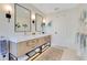 Elegant bathroom featuring double sinks, a modern vanity with ample storage, and minimalist decor at 6082 Twin Lakes Dr, Oviedo, FL 32765