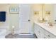 Bright bathroom featuring a white vanity with a sink, a framed mirror, and a tiled shower-tub combo at 6082 Twin Lakes Dr, Oviedo, FL 32765
