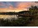 Scenic lake view with a private dock at sunset, perfect for relaxation and waterfront living at 6082 Twin Lakes Dr, Oviedo, FL 32765