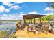Comfortable lounge furniture on a lakeside dock with seating and relaxing space to enjoy the view at 6082 Twin Lakes Dr, Oviedo, FL 32765