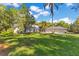 Exterior elevation showcases a spacious lawn, a home, and a three car garage at 6082 Twin Lakes Dr, Oviedo, FL 32765