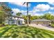 Exterior elevation features a spacious lawn, a home, and a detached three car garage at 6082 Twin Lakes Dr, Oviedo, FL 32765