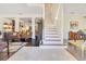 Bright foyer featuring tiled floors, a staircase, dark hardwood, and abundant natural light at 6082 Twin Lakes Dr, Oviedo, FL 32765
