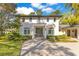 An attractive home features lush landscaping and a welcoming entrance with grey brick walkway at 6082 Twin Lakes Dr, Oviedo, FL 32765