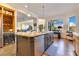 Gourmet kitchen featuring a large island with seating, granite countertops, and a wine fridge at 6082 Twin Lakes Dr, Oviedo, FL 32765