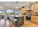 Bright kitchen featuring an island with seating, stainless steel appliances, and a view of a serene landscape at 6082 Twin Lakes Dr, Oviedo, FL 32765