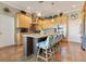 Modern kitchen with an island and bar seating, stainless steel appliances, and light wood cabinets at 6082 Twin Lakes Dr, Oviedo, FL 32765