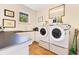 Bright laundry room equipped with a washer and dryer, ample counter space, and natural lighting at 6082 Twin Lakes Dr, Oviedo, FL 32765