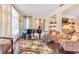 Spacious living room with hardwood floors, neutral paint, and a grand piano at 6082 Twin Lakes Dr, Oviedo, FL 32765