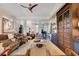 Expansive living room featuring wood floors, custom cabinetry and shelving, and comfortable seating at 6082 Twin Lakes Dr, Oviedo, FL 32765