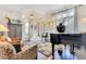 Inviting living room boasts a grand piano, patterned rug, and staircase leading to upper level at 6082 Twin Lakes Dr, Oviedo, FL 32765