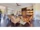 Open-concept living room featuring wood floors, custom cabinetry and shelving, and comfortable seating at 6082 Twin Lakes Dr, Oviedo, FL 32765