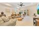 Cozy living room featuring comfortable seating, decorative wall art, and a ceiling fan at 6082 Twin Lakes Dr, Oviedo, FL 32765