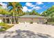 Three car garage features neutral paint, driveway with grey brick pavers, and mature landscaping at 6082 Twin Lakes Dr, Oviedo, FL 32765
