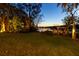 Tranquil waterfront view of the lake at dusk with a gazebo and lush greenery, creating a peaceful retreat at 6082 Twin Lakes Dr, Oviedo, FL 32765