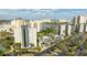 Aerial view of 'The Enclave' building with surrounding landscape, city view, and parking at 6165 Carrier Dr # 3602, Orlando, FL 32819