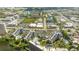 Expansive aerial view showing the real estate property with a lake, buildings and the cityscape at 6165 Carrier Dr # 3602, Orlando, FL 32819
