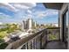 Balcony view overlooking a well-maintained landscape, buildings, and a blue sky at 6165 Carrier Dr # 3602, Orlando, FL 32819