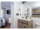 Modern bathroom featuring a bright vanity, black hardware, and tiled shower area near the bedroom at 6165 Carrier Dr # 3602, Orlando, FL 32819