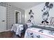 Bright bedroom featuring two twin beds, Disney themed decor and geometric accent wall with modern lighting at 6165 Carrier Dr # 3602, Orlando, FL 32819