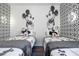 Bright bedroom featuring two twin beds with Disney themed decor and geometric accent wall at 6165 Carrier Dr # 3602, Orlando, FL 32819