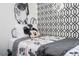 A bedroom featuring Disney themed decor, twin bed, and geometric accent wall at 6165 Carrier Dr # 3602, Orlando, FL 32819