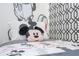 Close up of twin bed in the charming bedroom featuring whimsical Mickey Mouse decor at 6165 Carrier Dr # 3602, Orlando, FL 32819