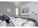 Bright bedroom with two twin beds, Disney themed decor, geometric accent wall and TV at 6165 Carrier Dr # 3602, Orlando, FL 32819