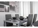 A modern dining table with seating for four, and unique monochrome art at 6165 Carrier Dr # 3602, Orlando, FL 32819