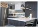 Bright kitchen featuring stainless steel refrigerator, modern appliances, and sleek breakfast bar with seating at 6165 Carrier Dr # 3602, Orlando, FL 32819
