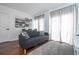 Bright and modern living room with dark hardwood floors and plenty of natural light from the window at 6165 Carrier Dr # 3602, Orlando, FL 32819