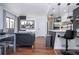 Open-concept living and kitchen area with dining table, island seating, and a flat-screen TV at 6165 Carrier Dr # 3602, Orlando, FL 32819
