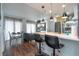 Bright living area with kitchen island, dining table, and comfortable seating next to a large window at 6165 Carrier Dr # 3602, Orlando, FL 32819