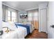 Bright main bedroom features neutral decor, a flatscreen TV, and hardwood floors at 6165 Carrier Dr # 3602, Orlando, FL 32819