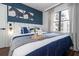 Stylish main bedroom features hardwood floors, flatscreen TV, and an accent wall with view at 6165 Carrier Dr # 3602, Orlando, FL 32819