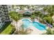 Relaxing pool with spa and plenty of lounge chairs surrounded by palm trees and well-manicured landscaping at 6165 Carrier Dr # 3602, Orlando, FL 32819