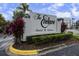 Community sign: The Enclave, Hotel & Suites. Lush landscaping and colorful foliage surround at 6165 Carrier Dr # 3602, Orlando, FL 32819